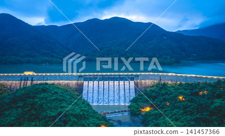 Hong Kong, July 18 2026 Evening aerial view of illuminated Tai Tam Dam. Hong Kong, July 18 2026 Evening aerial view of illuminated Tai Tam Dam. 141457366