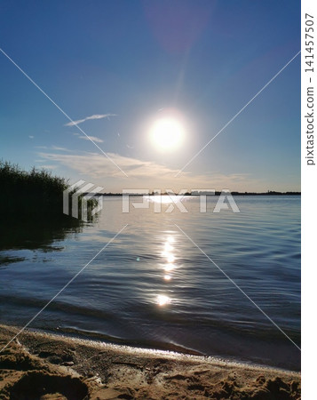 bright sunny sunset on the lake shore bright sunny sunset on the lake shore 141457507