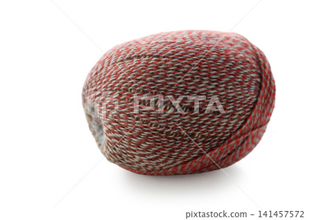 Vibrant yarn ball resting in soft light with intricate patterns and colors 141457572