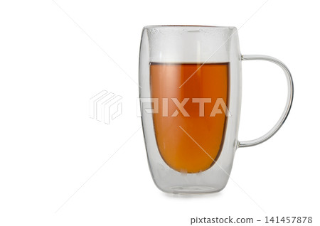 Double-walled glass mug filled with tea Double-walled glass mug filled with tea 141457878