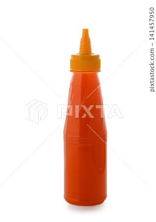 Plastic squeeze bottle filled with orange sauce on a white background Plastic squeeze bottle filled with orange sauce on a white background 141457950