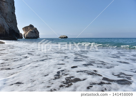 Aphrodite Rock sea stacks rising from the Mediterranean waters by a pebble beach, Cyprus Aphrodite Rock sea stacks rising from the Mediterranean waters by a pebble beach, Cyprus 141458009