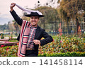 Portrait of a smiling, cheerful young man dressed as a Chilean huaso, celebrating and posing to dance cueca, a traditional Chilean dance. Chilean traditions, celebration, and culture. 141458114