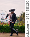 Portrait of a smiling, cheerful young man dressed as a Chilean huaso, celebrating and posing to dance cueca, a traditional Chilean dance. Chilean traditions, celebration, and culture. 141458120