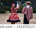 A pair of young Chilean Latin dancers dancing cuecas, the Chilean national dance, in a very cheerful, charismatic, and romantic manner. Chilean Independence Day  141458121