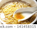 Scoop the soup from the cup noodles with a spoon. 141458315