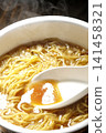 Scoop the soup from the cup noodles with a spoon. 141458321