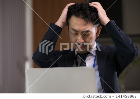 Japanese businessmen are troubled by computer problems and work-related issues due to overtime work. Japanese businessmen are troubled by computer problems and work-related issues due to overtime work. 141458962
