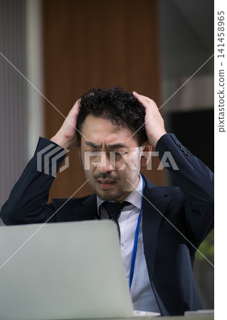 Japanese businessmen are troubled by computer problems and work-related issues due to overtime work. Japanese businessmen are troubled by computer problems and work-related issues due to overtime work. 141458965