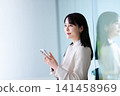 Woman operating a smartphone 141458969