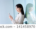 Woman operating a smartphone 141458970