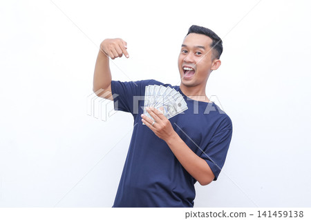 Man beams joyfully, flexing arm proudly. He holds money in one hand, smiling widely. Studio lighting highlights his enthusiastic expression. Perfect for business, finance, or success-themed projects Man beams joyfully, flexing arm proudly. He holds money in one hand, smiling widely. Studio lighting highlights his enthusiastic expression. Perfect for business, finance, or success-themed projects 141459138