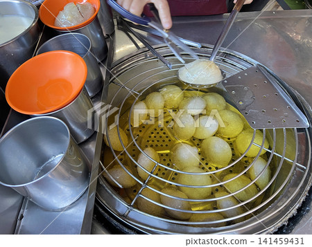 拍攝在油鍋裡保溫並準備販售的肉圓 拍攝在油鍋裡保溫並準備販售的肉圓 141459431