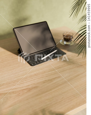 Modern workspace mockup with tablet stylus coffee cup on wooden table 3D rendering Modern workspace mockup with tablet stylus coffee cup on wooden table 3D rendering 141459995