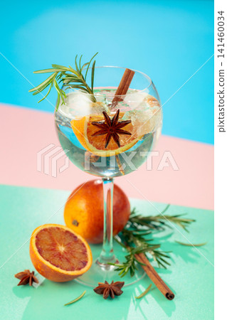 Summer cocktail with gin, tonic, blood orange, cinnamon, anise, and rosemary. Summer cocktail with gin, tonic, blood orange, cinnamon, anise, and rosemary. 141460034
