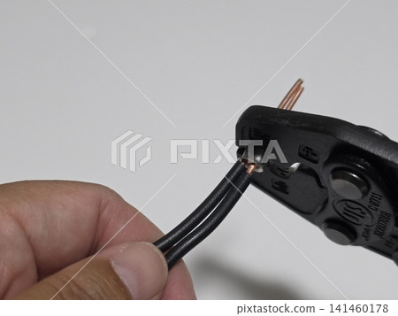 Electrician's exam practice: Crimping ring sleeves with a crimping tool (electrician's pliers) Electrician's exam practice: Crimping ring sleeves with a crimping tool (electrician's pliers) 141460178
