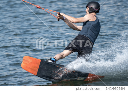Cable Wakeboarder Riding on Lake in Summer 141460664