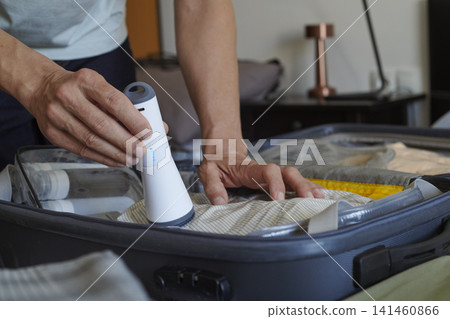 packing a suitcase with vacuum storage bags packing a suitcase with vacuum storage bags 141460866