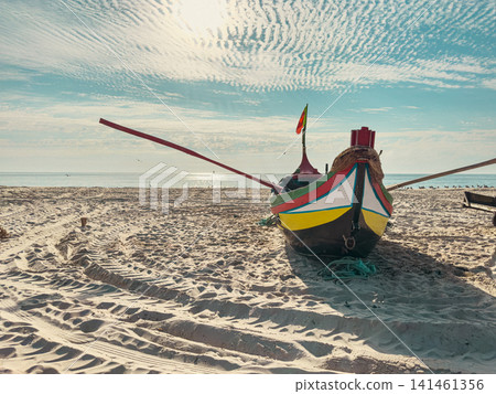 Traditional Portuguese fishing boat on sandy beach Traditional Portuguese fishing boat on sandy beach 141461356