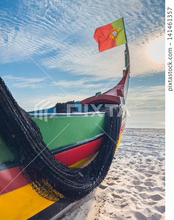 Traditional Portuguese fishing boat on sandy beach Traditional Portuguese fishing boat on sandy beach 141461357