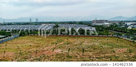 Aerial view of a housing cluster and vacant land Aerial view of a housing cluster and vacant land 141462336