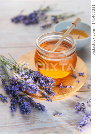 Lavender flowers and natural honey on wooden background Lavender flowers and natural honey on wooden background 141463331