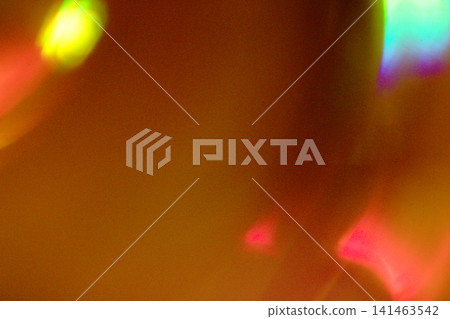 Abstract colorful light reflections creating a vibrant pattern with hues of red, green, and blue against a soft orange background Abstract colorful light reflections creating a vibrant pattern with hues of red, green, and blue against a soft orange background 141463542