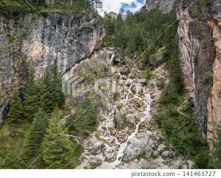 Close drone view of Ciastlins Waterfalls and a wooden footbridge in South Tyrol, Italy 141463727