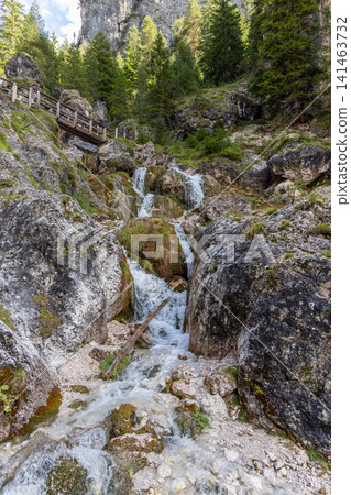 Stepped Ciastlins cascade between boulders below a footbridge in South Tyrol, Italy Stepped Ciastlins cascade between boulders below a footbridge in South Tyrol, Italy 141463732
