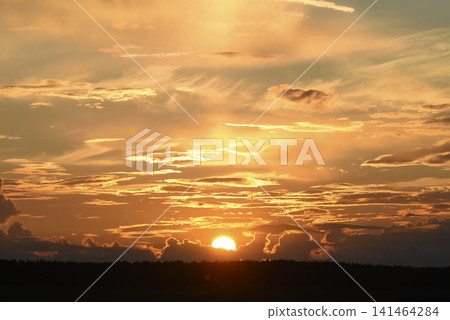 The evening horizon. The sun is in the clouds. A bright yellow-pink sunset. 141464284