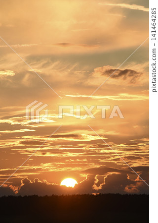 The evening horizon. The sun is in the clouds. A bright yellow-pink sunset. The evening horizon. The sun is in the clouds. A bright yellow-pink sunset. 141464285