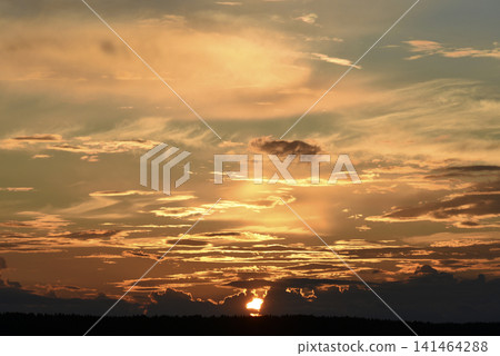 The evening horizon. The sun is in the clouds. A bright yellow-pink sunset. 141464288