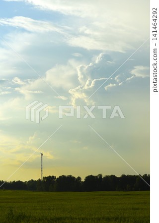 The evening horizon in the clouds and the communications tower. 141464292