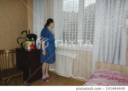 elderly woman soft blue robe stands window, gazing out through delicate lace curtains quiet anticipation poignant moment patience, memory tender longing speaks depth human emotion stories hidden elderly woman soft blue robe stands window, gazing out through delicate lace curtains quiet anticipation poignant moment patience, memory tender longing speaks depth human emotion stories hidden 141464449