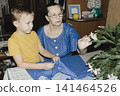 gentle grandmother blue top patiently shows her young grandson how sew piece fabric focused collaboration capturing warmth family learning passing traditions quiet joy creating something together 141464526