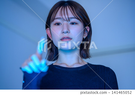 A woman who controls the future with her fingers A woman who controls the future with her fingers 141465052