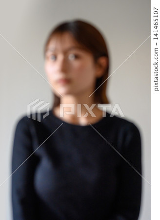 Portrait of a young woman in black clothing Portrait of a young woman in black clothing 141465107