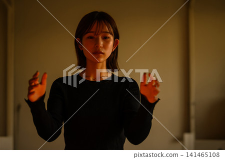 A woman's hand illuminated by light A woman's hand illuminated by light 141465108