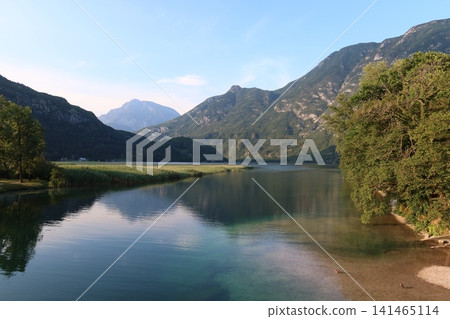 Alpine Peak and Mountain Reflection on Calm Lake in Italy Alpine Peak and Mountain Reflection on Calm Lake in Italy 141465114