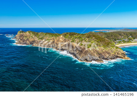 Aerial view of the rugged rocky coastline and crystal-clear turquoise water along the shoreline at Seal Rocks, NSW, Australia, showcasing the natural beauty of this iconic coastal destination. Aerial view of the rugged rocky coastline and crystal-clear turquoise water along the shoreline at Seal Rocks, NSW, Australia, showcasing the natural beauty of this iconic coastal destination. 141465196