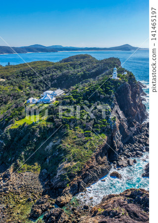 Aerial vertical view of the historic Seal Rocks Lighthouse overlooking the rugged coastline, deep blue ocean and surrounding coastal landscape at Seal Rocks, NSW, Australia. Aerial vertical view of the historic Seal Rocks Lighthouse overlooking the rugged coastline, deep blue ocean and surrounding coastal landscape at Seal Rocks, NSW, Australia. 141465197
