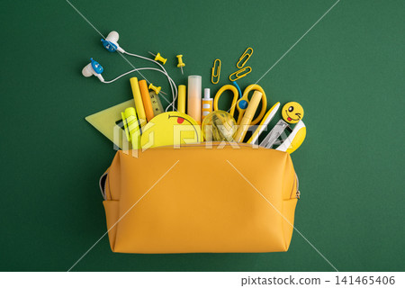 Yellow pencil case opening with school supplies Yellow pencil case opening with school supplies 141465406