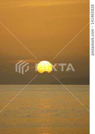 Close-up of empty sky and sun for copy space. The spectacular view of the sunset was breathtaking, with the sun sinking behind the clouds on the horizon. Close-up of empty sky and sun for copy space. The spectacular view of the sunset was breathtaking, with the sun sinking behind the clouds on the horizon. 141465826