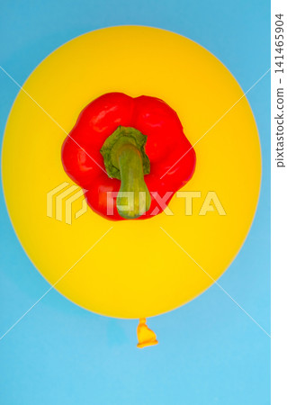 The top part of sweet red pepper on a yellow balloon, for decoration, for text design, for template. The top part of sweet red pepper on a yellow balloon, for decoration, for text design, for template. 141465904