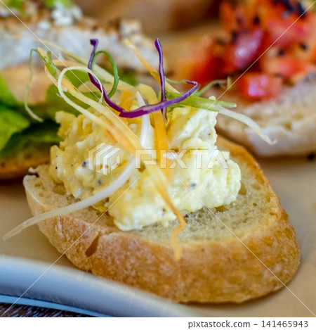 Creamy egg salad open sandwich on toasted bread with fresh vegetable garnish close up, healthy homemade breakfast or brunch concept, selective focus food photography Creamy egg salad open sandwich on toasted bread with fresh vegetable garnish close up, healthy homemade breakfast or brunch concept, selective focus food photography 141465943