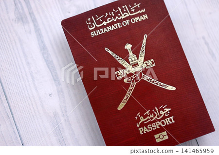 Omani passport on table close up. Official identification document book for citizens of Oman Omani passport on table close up. Official identification document book for citizens of Oman 141465959