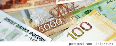 Russian ruble paper banknotes pile on table. Russia RUB currency money bills in big amount Russian ruble paper banknotes pile on table. Russia RUB currency money bills in big amount 141465964