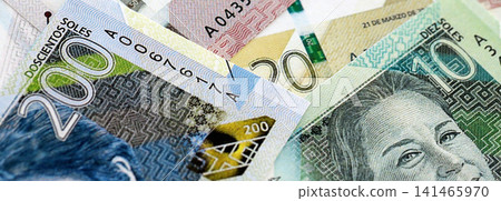 Peruvian sol paper banknotes pile on table. Peru PEN currency money bills in big amount Peruvian sol paper banknotes pile on table. Peru PEN currency money bills in big amount 141465970