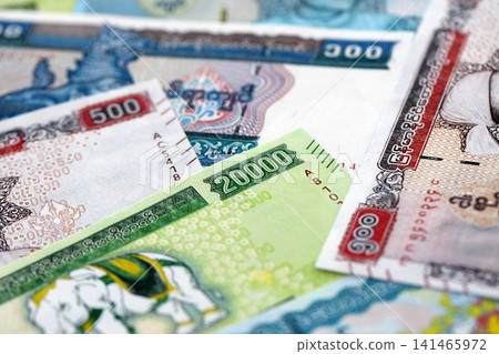 Myanmar kyat paper banknotes pile on table. Myanmar MMK currency money bills in big amount Myanmar kyat paper banknotes pile on table. Myanmar MMK currency money bills in big amount 141465972