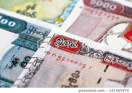Myanmar kyat paper banknotes pile on table. Myanmar MMK currency money bills in big amount Myanmar kyat paper banknotes pile on table. Myanmar MMK currency money bills in big amount 141465974